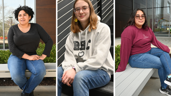 Three girls sitting on campus