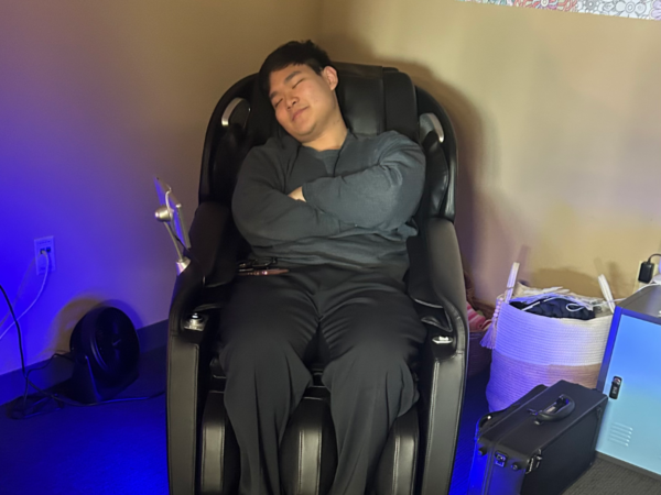 Man sitting in zen zone massage chair.