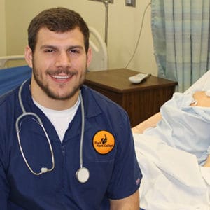 Male nursing student in scrubs
