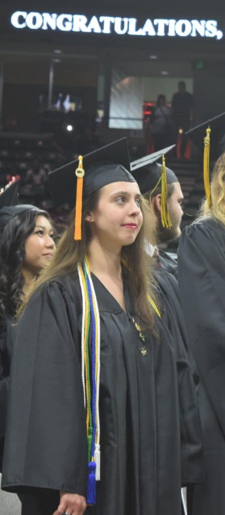female grad wearing honors cords