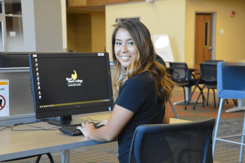 Student in advising center at a Black Hawk College computer