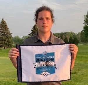 golfer Rielly McGranahan holding small tournament banner