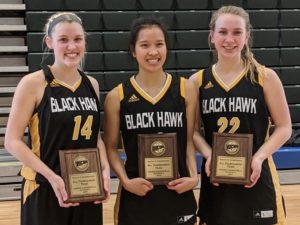3 smiling women's basketball players holding awards