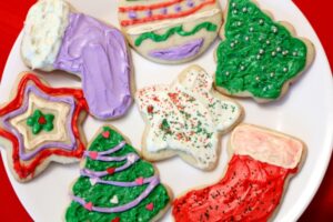 7 decorated holiday sugar cookies on a plate