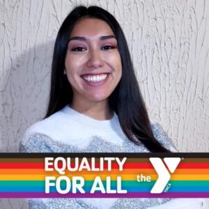 smiling woman with a rainbow banner across the bottom of photo that says Equality for All and the Y