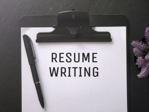 words resume writing on a paper on a clipboard