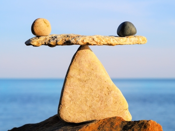 balancing stones with water in background