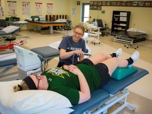 PTA student using ultrasound on leg