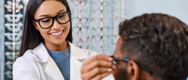 Optician assisting a customer with glasses