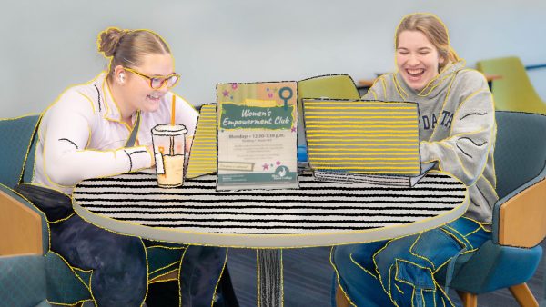 Two people at a table with laptop.