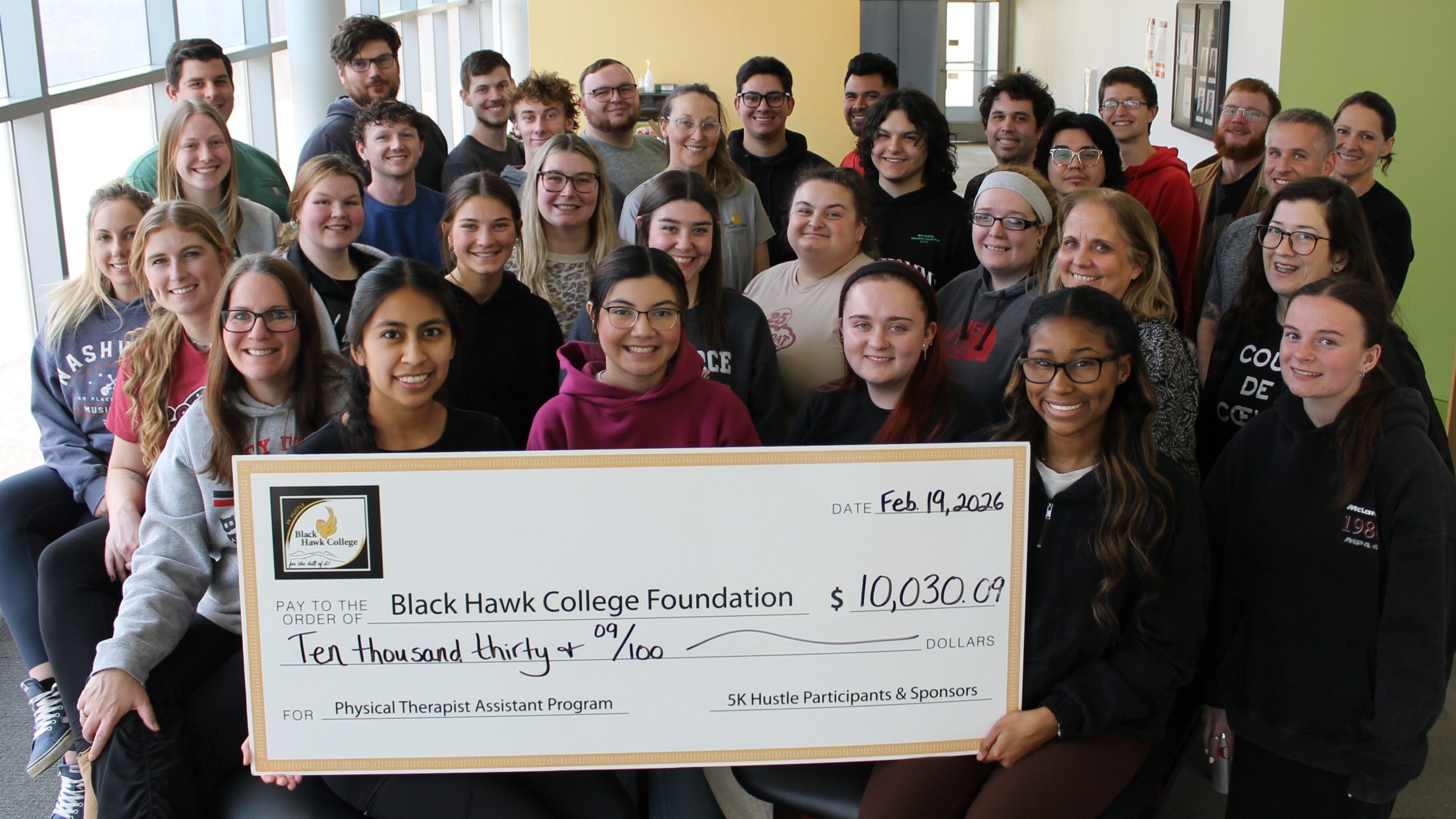 33 people with oversized check.