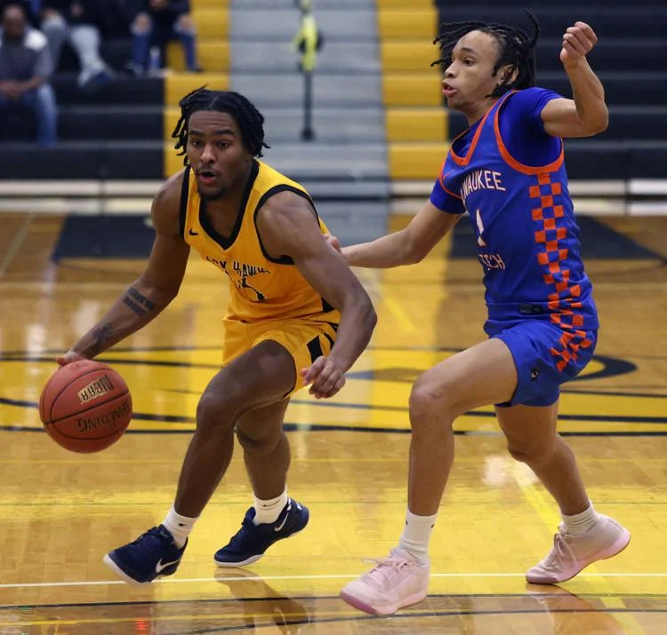 Basketball players in action on court.