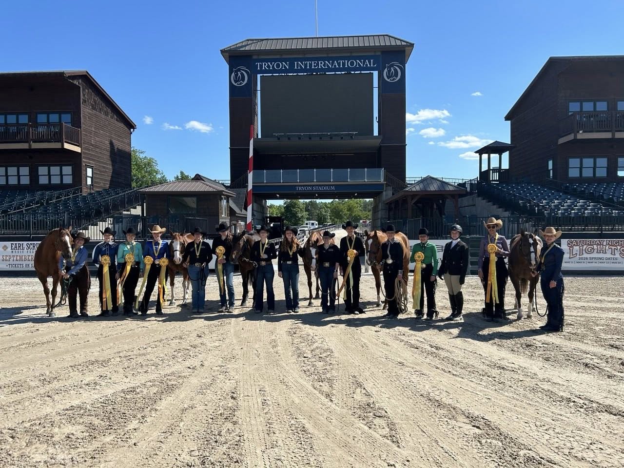 2026 ihsa equine riding team in front of the tryon international sign