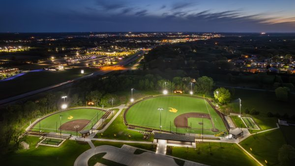 Illuminated sports fields under night sky