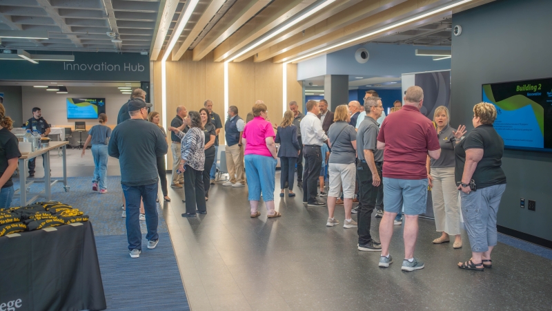 Bhc, community celebrate building 2 renovation Building lobby with group of people.