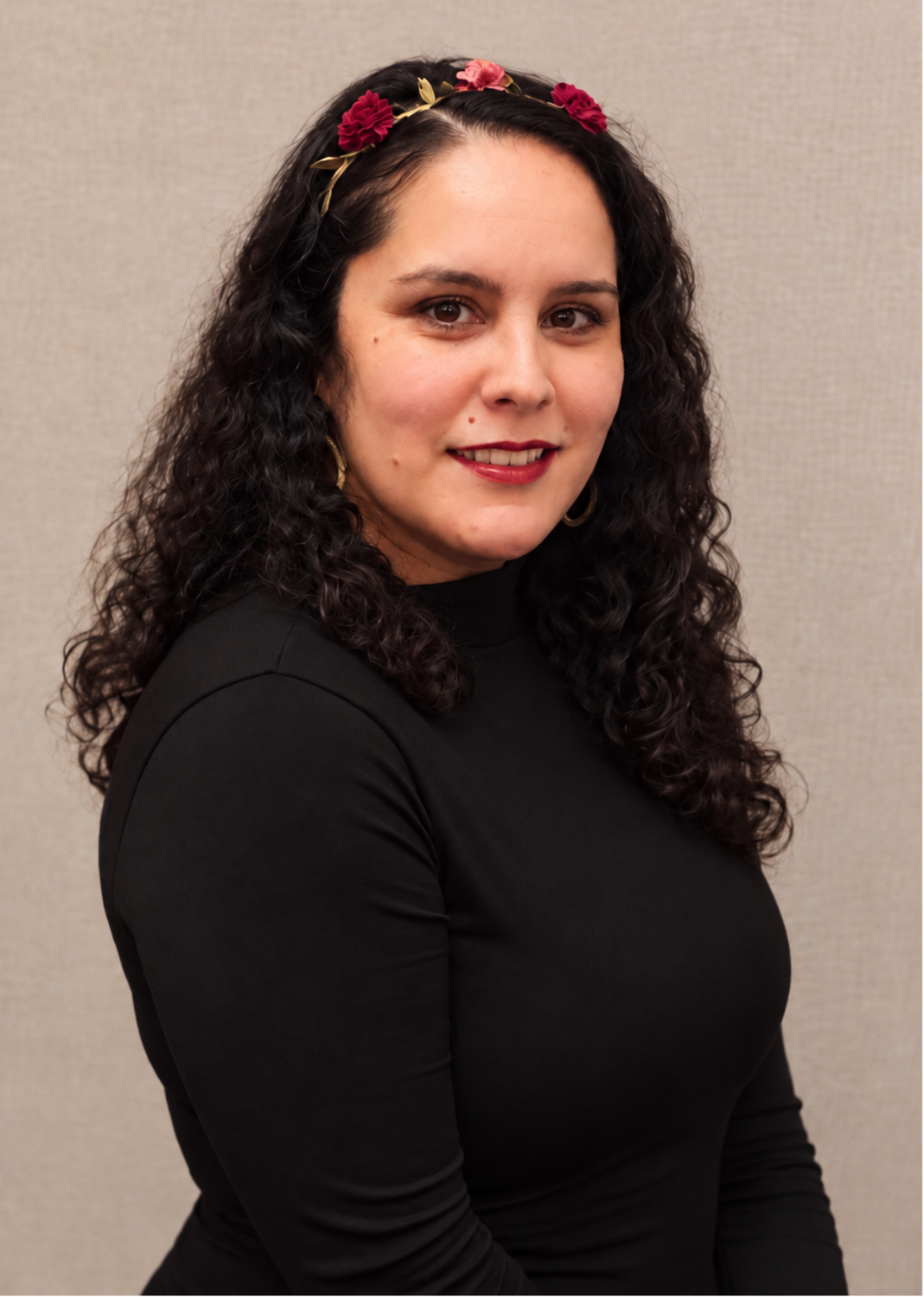 Woman with turtle neck and headband smiling at camera