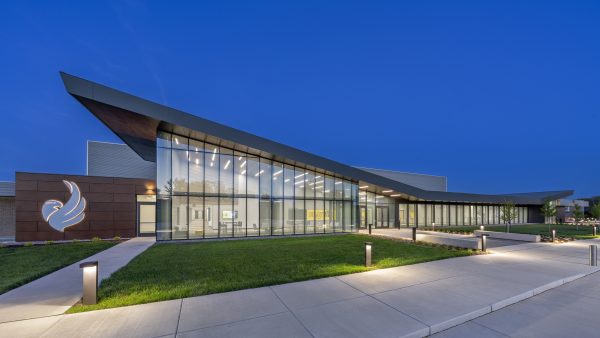 Modern building illuminated at dusk.
