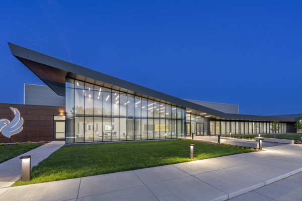 Modern building illuminated at dusk.