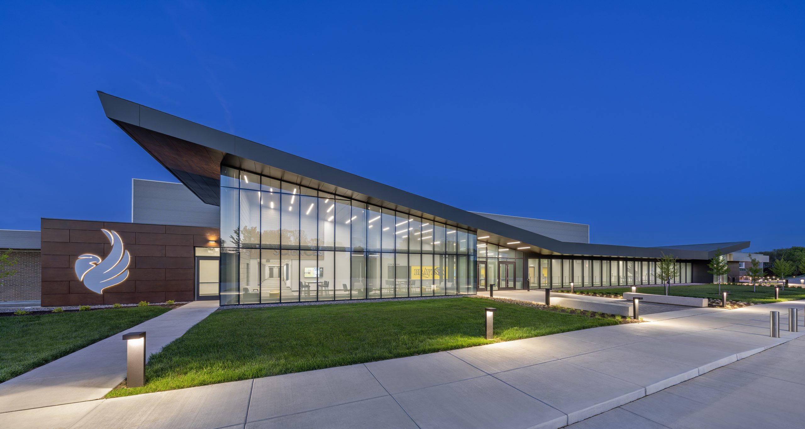 Modern building illuminated at dusk.