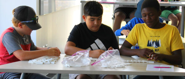 A group of boys sitting at a table