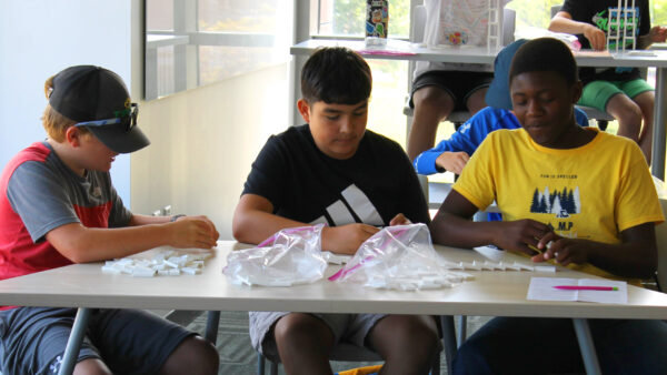 Professional and continuing education A group of boys sitting at a table