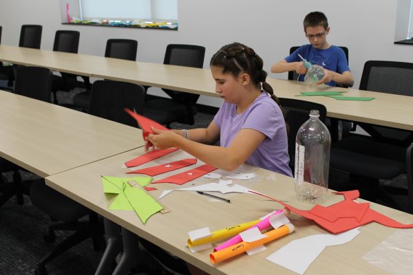 Over 500 students explore passions at college for kids Girl in purple shirt in rockets class