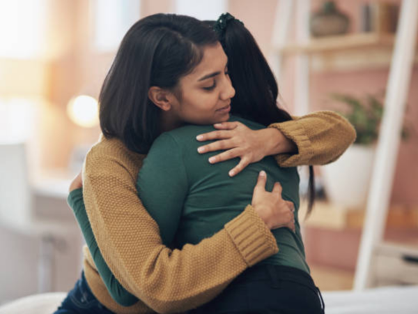 Two women hugging for comfort
