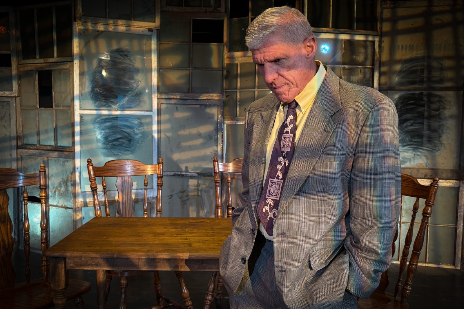 Bhc, mockingbird stage 'death of a salesman' An actor looking down giving a serious look while rehearsing