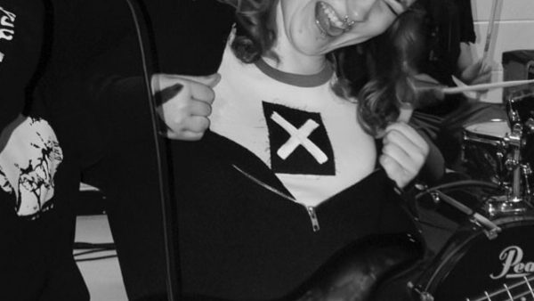 Photo of daisy blunt playing the bass with her band