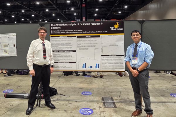 Two men presenting research poster