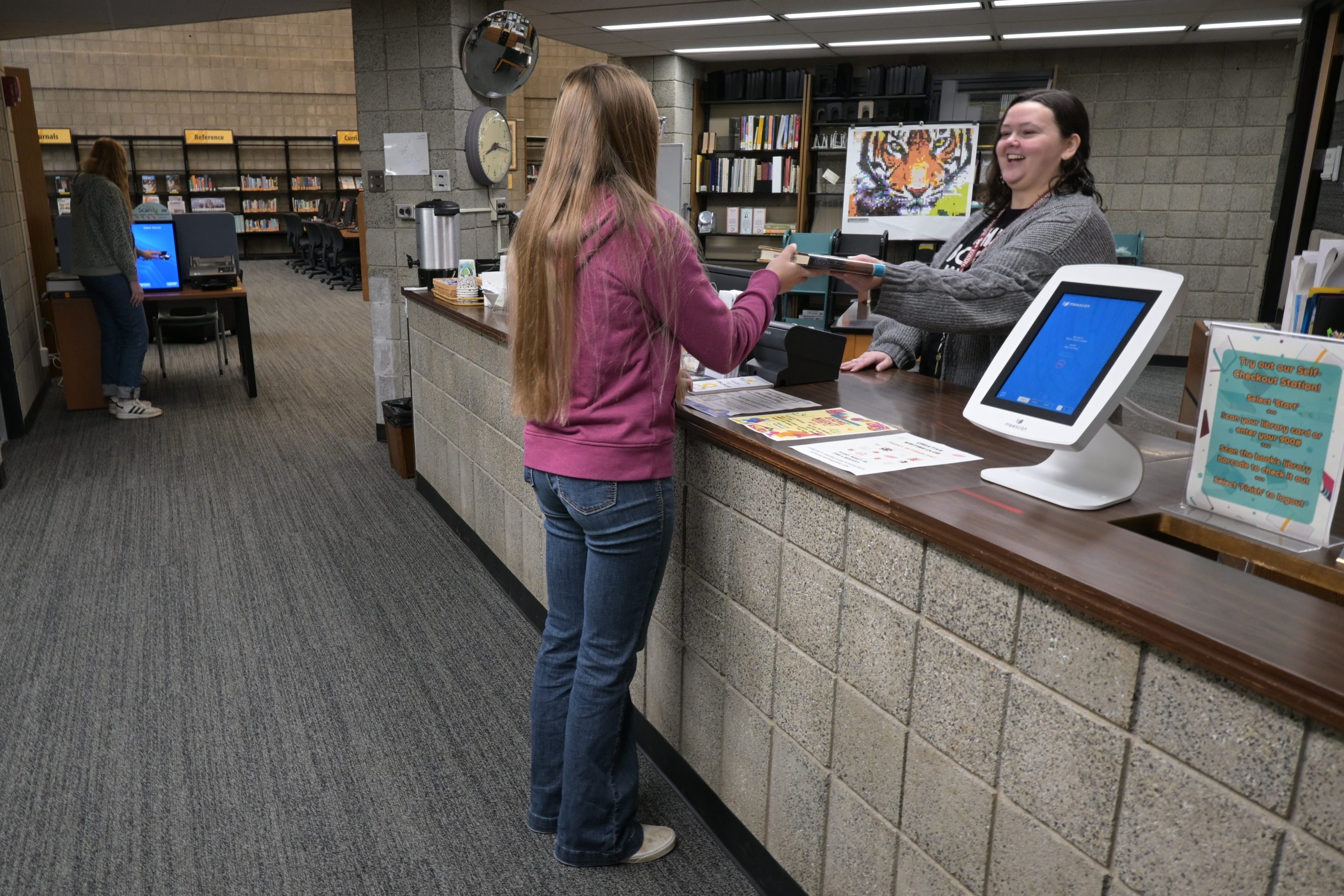 Library checkout desk with patron.