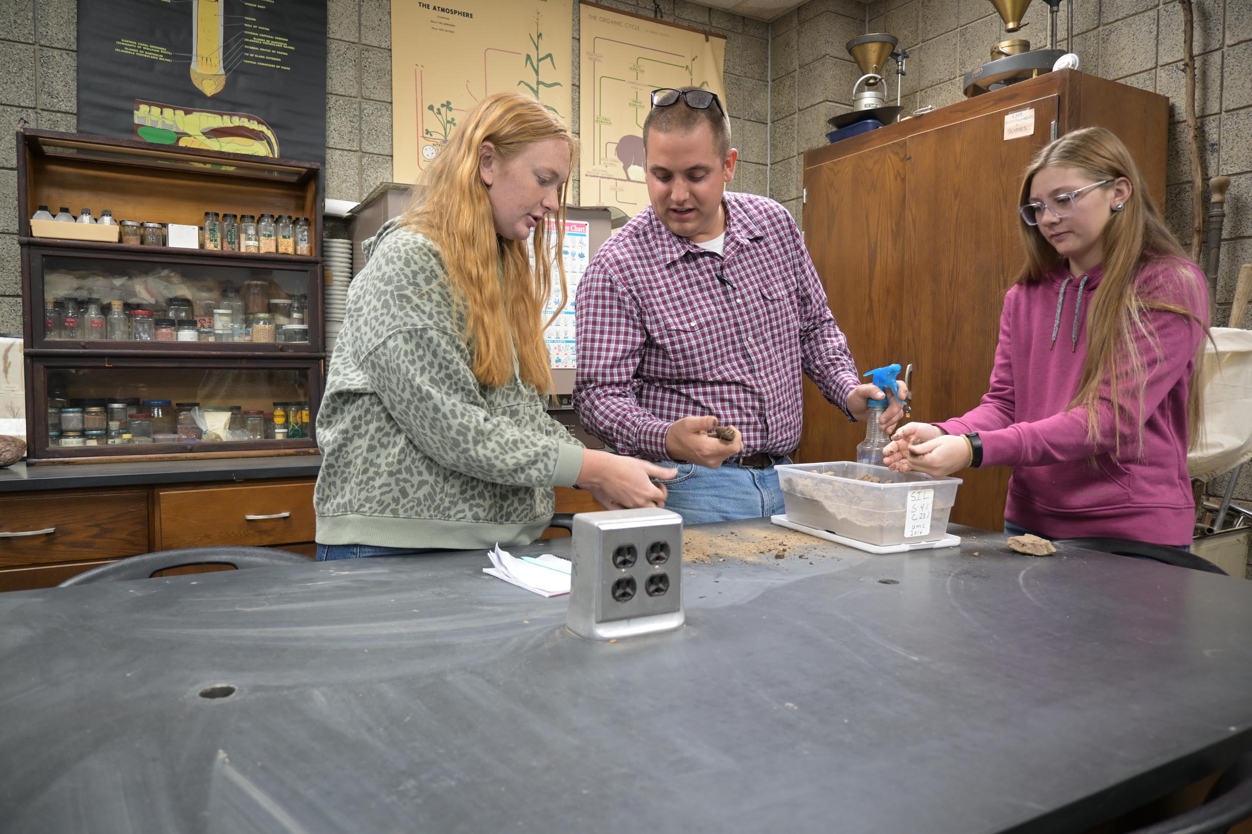 Sow your future at black hawk college Students conducting an experiment together.
