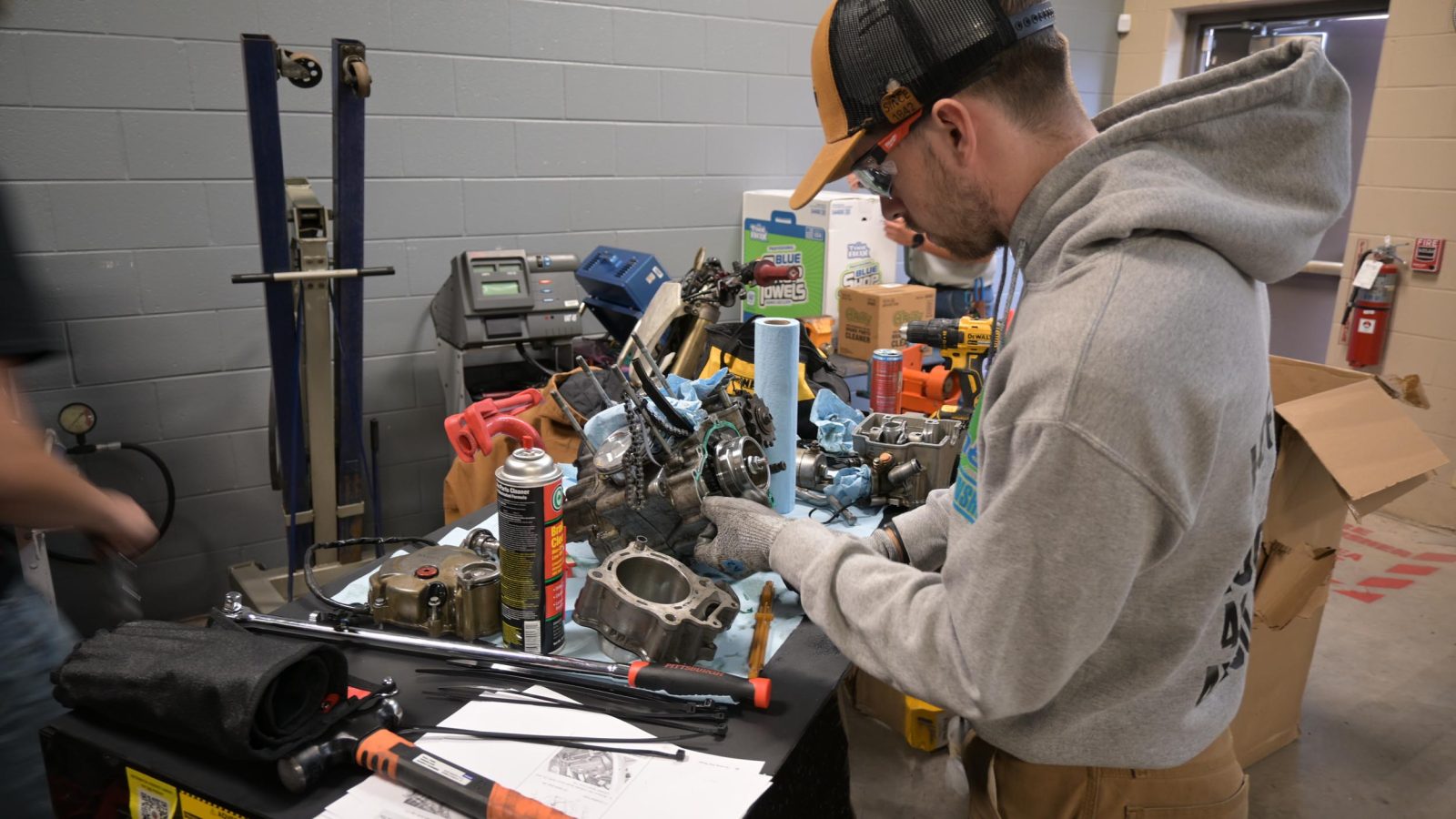 Person working on engine components.