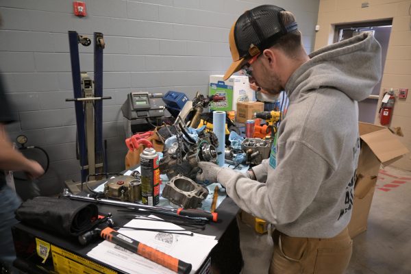 Community colleges and the courage to build what comes next Person working on engine components.