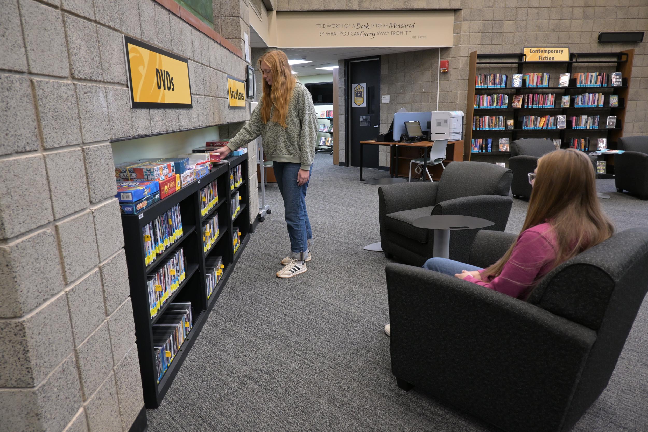 Students browsing dvds in library