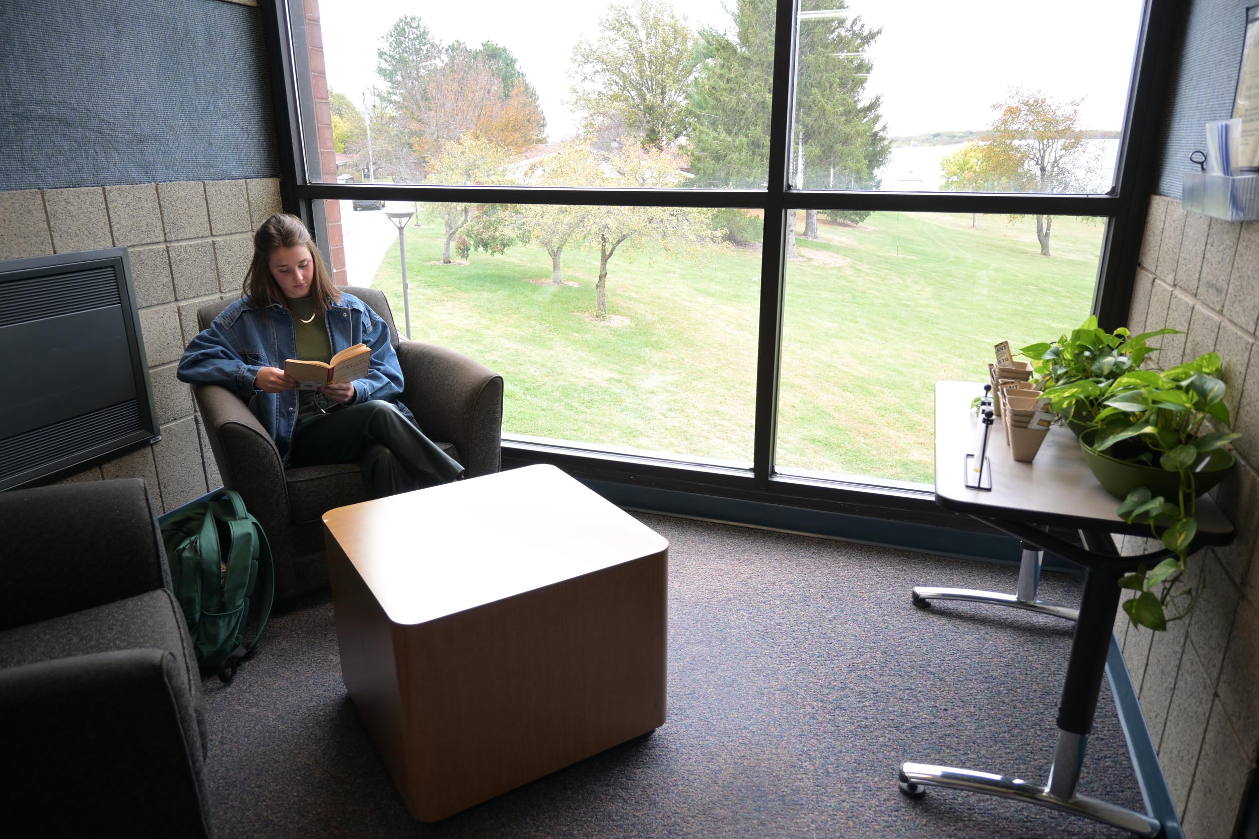 Student reading in a cozy corner.