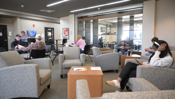 Academic departments Students socializing in a lounge area.