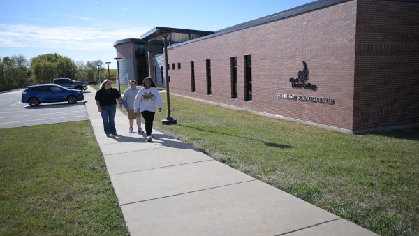 Students walking near campus building.