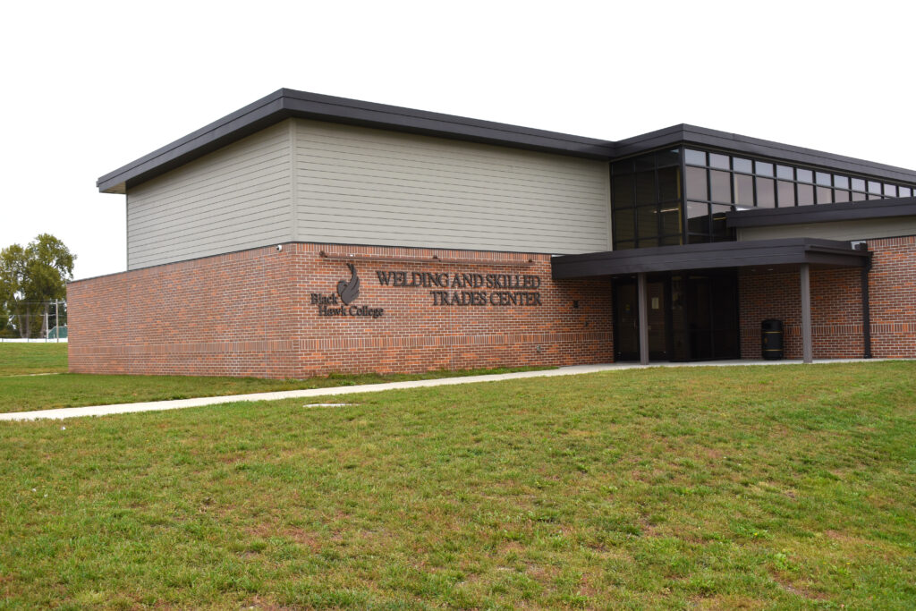 A brick building with a lawn