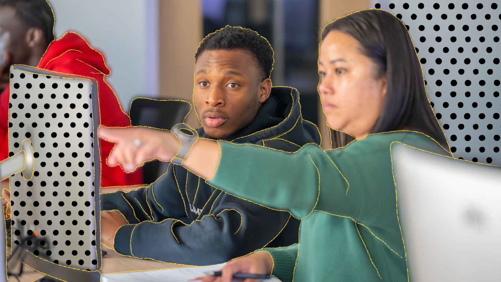 Two students looking at a computer working together.