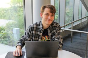 A person sitting at a table with a laptop
