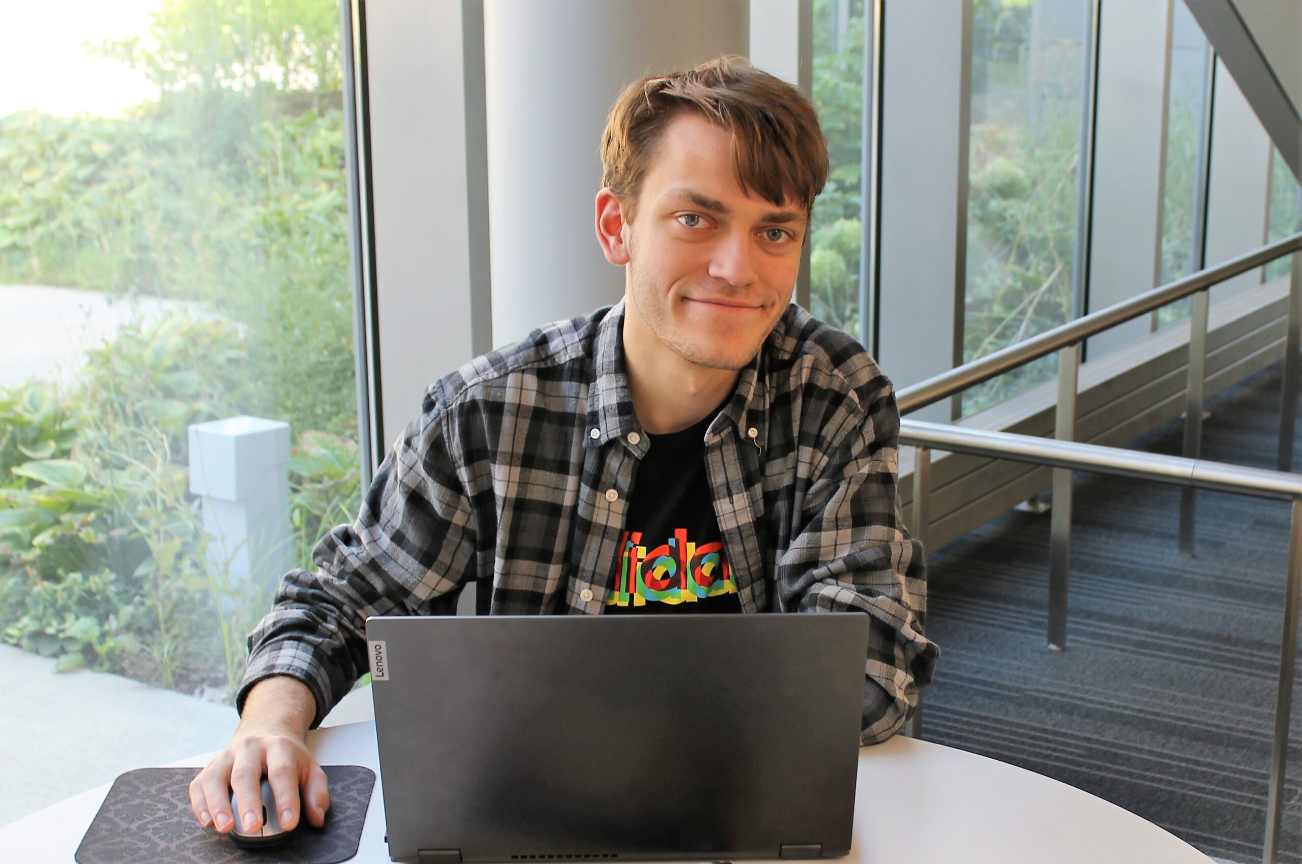 A person sitting at a table with a laptop