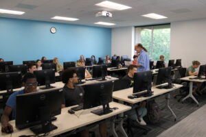 A group of people in a room with computers