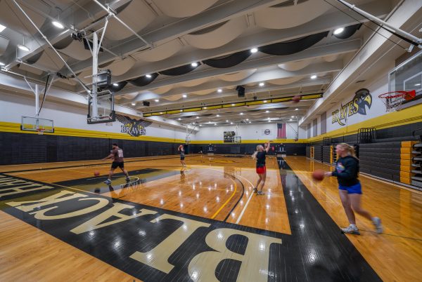 A group of people playing basketball in a gym