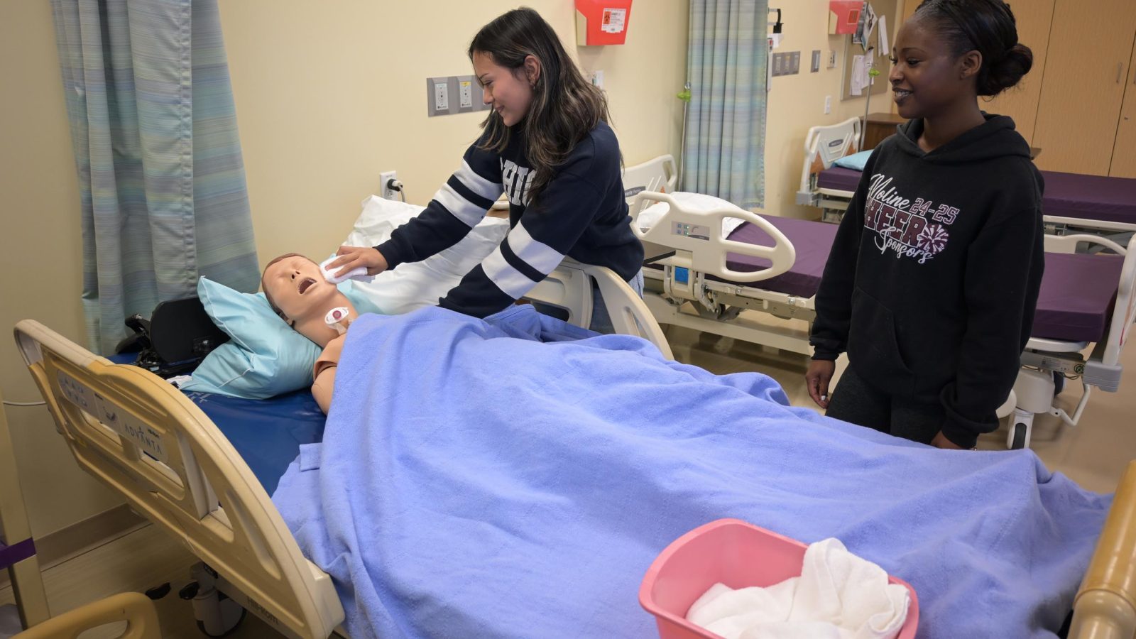 Students practicing patient care techniques.
