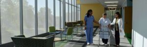 A nurse standing in a room with chairs and tables