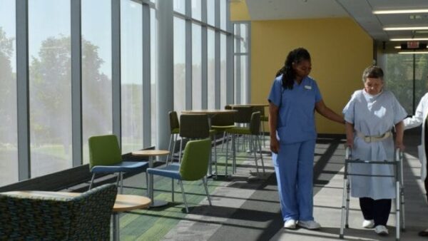 Academic departments A person in blue scrubs standing in a room with windows