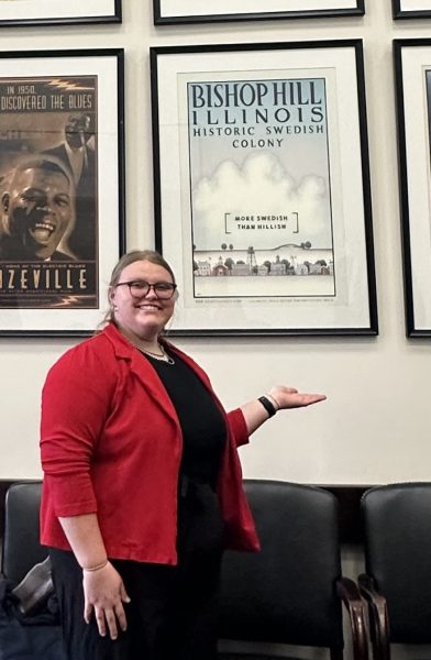 Makenna in front of a poster for an illinois swedish community