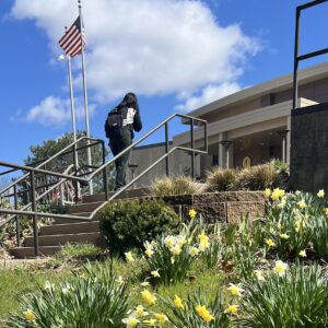 A person walking up stairs in front of a building