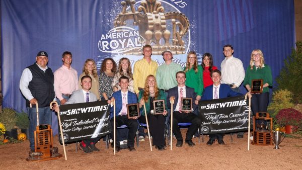 Group photo of black hawk east’s winning junior college livestock judging team holding plaques and banners at the 2025 american royal.